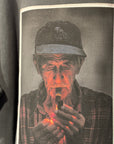 Sweatshirt with a graphic of a man holding a lit match against a dark background