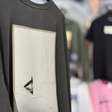 Black sweatshirt with a black and white patch featuring a surfer debating to go out into the water.