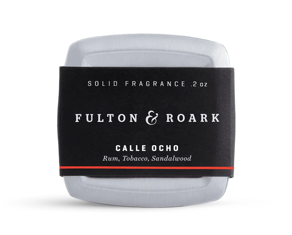 Solid fragrance container with 'Fulton & Roark' label on a white background