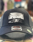Black cap with a printed  church design on a blurred background
