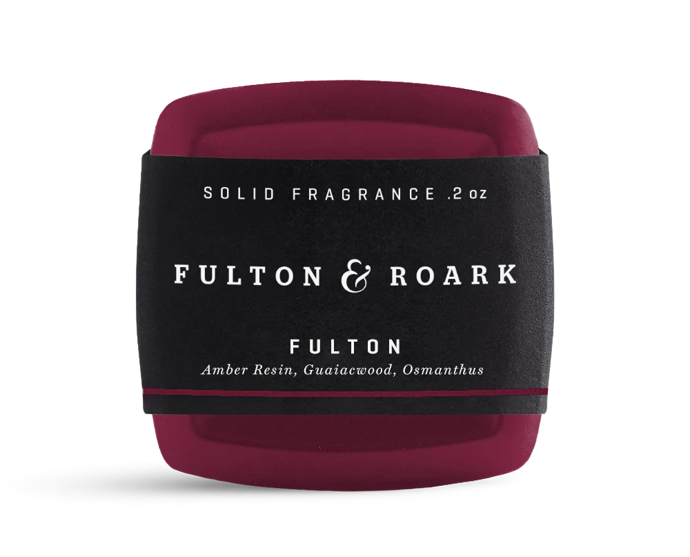 Solid fragrance container with 'Fulton & Roark' branding on a white background