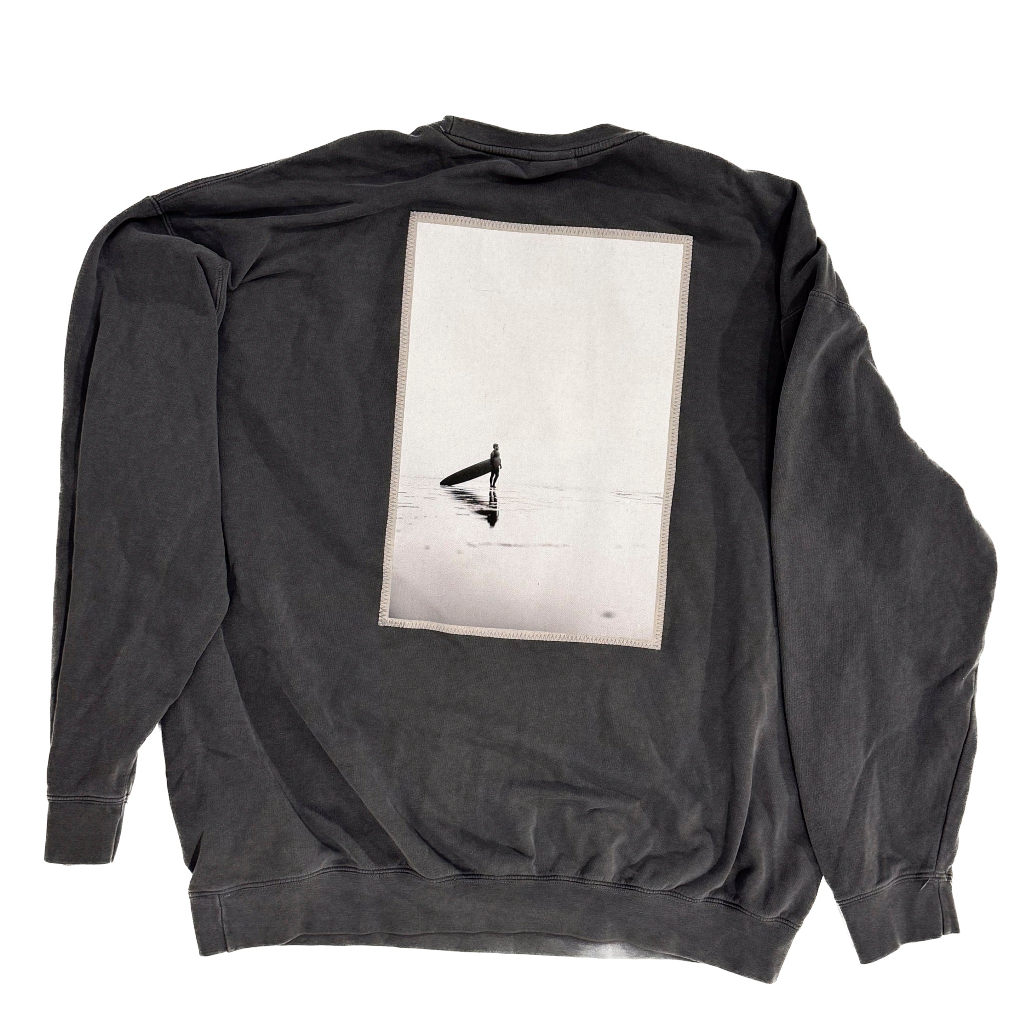Black sweatshirt with a graphic design on the back against a white background