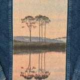 Embroidered design of western lake on a denim fabric