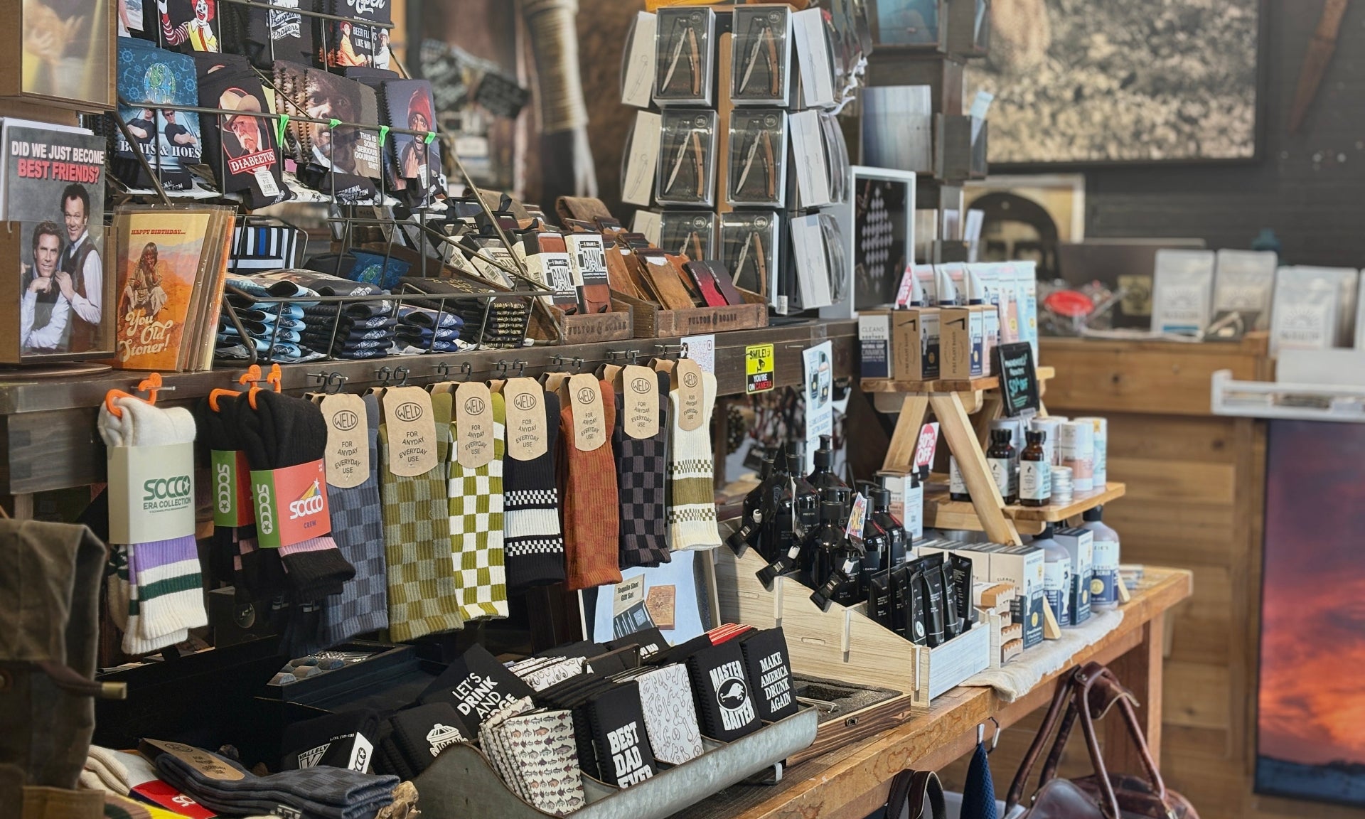 Store interior with shelves displaying various items including bags and clothing.