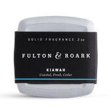 Solid fragrance bar with 'Fulton & Roark' label on a white background
