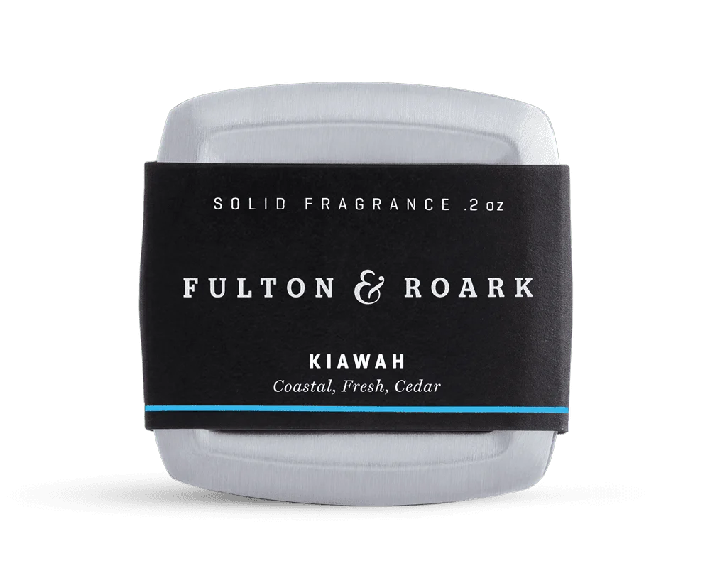 Solid fragrance bar with 'Fulton & Roark' label on a white background