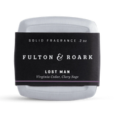 Solid fragrance container with 'Fulton & Roark' label on a white background