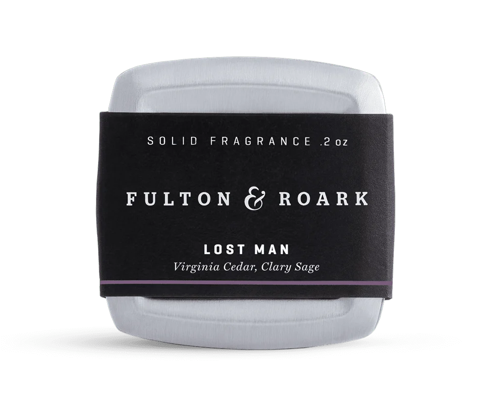 Solid fragrance container with 'Fulton & Roark' label on a white background