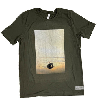 Green t-shirt with a graphic of a baby turtle
