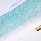 Aerial view of yellow beach umbrellas along turquoise Gulf water and white sand on Florida’s 30A coast.