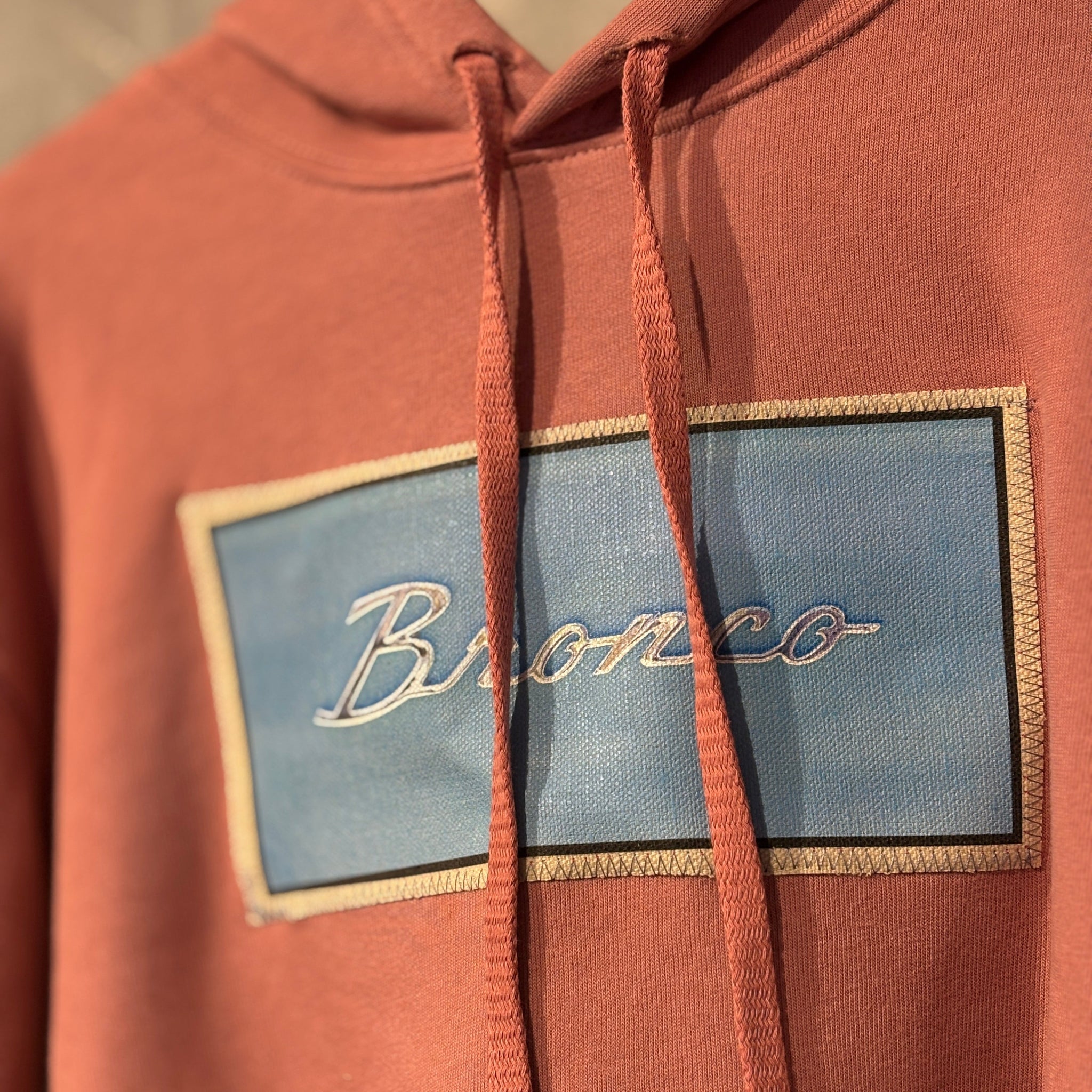 Brown hoodie with 'Bronco' logo on chest