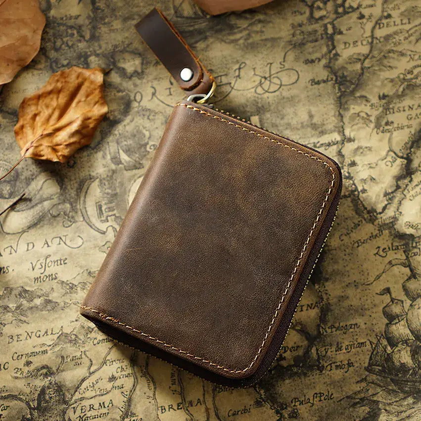 Brown leather wallet on an old map background