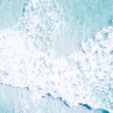 Aerial photo of turquoise waves breaking over white sand at Grayton Beach, Florida.