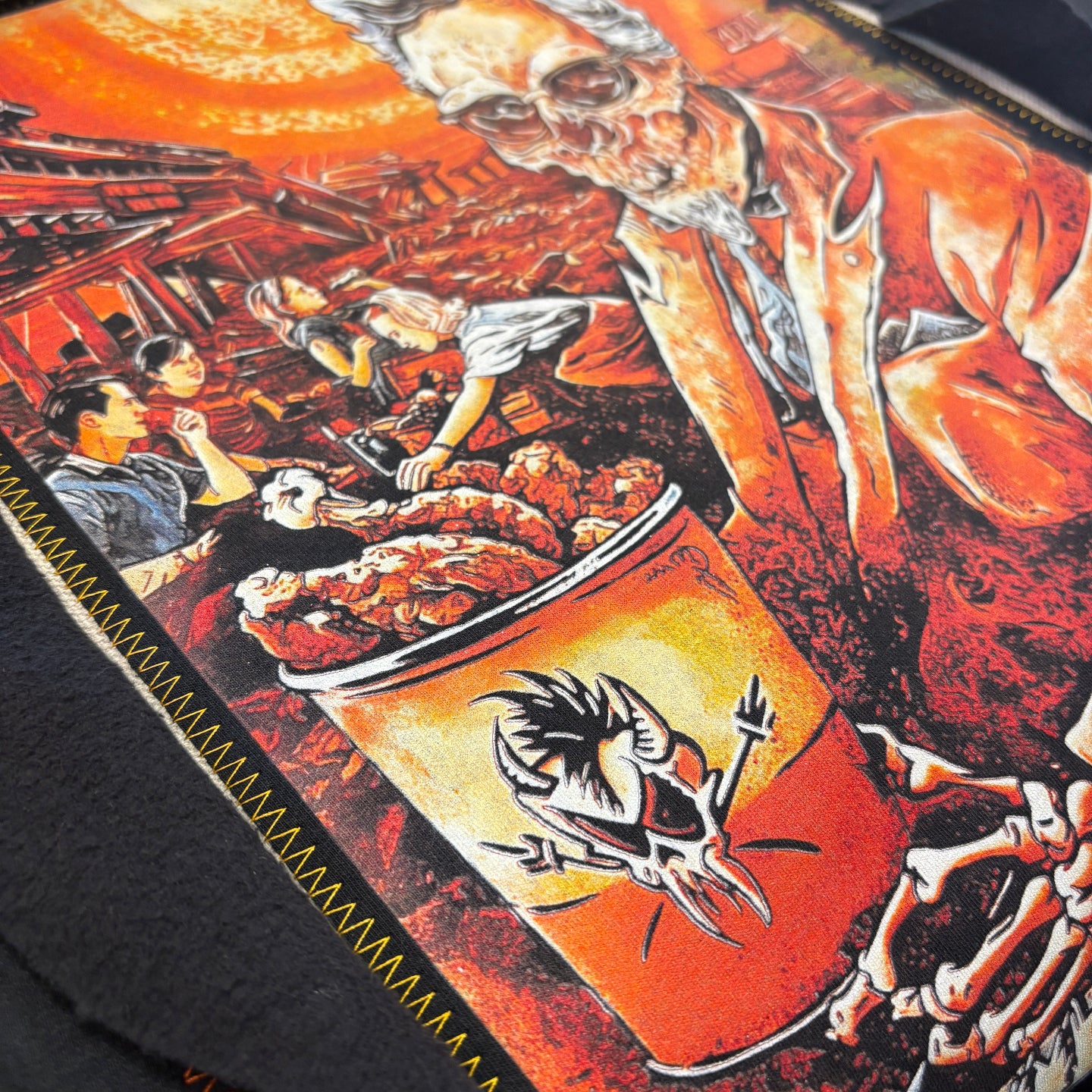 Close-up of a graphic design on a product with a prominent logo and artistic elements.