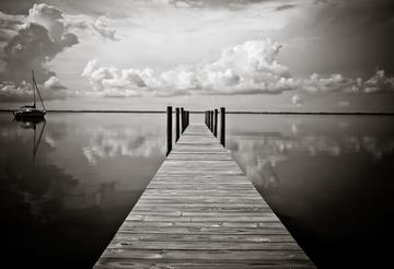 Calm coastal water reflecting soft sky near 30A dunes.