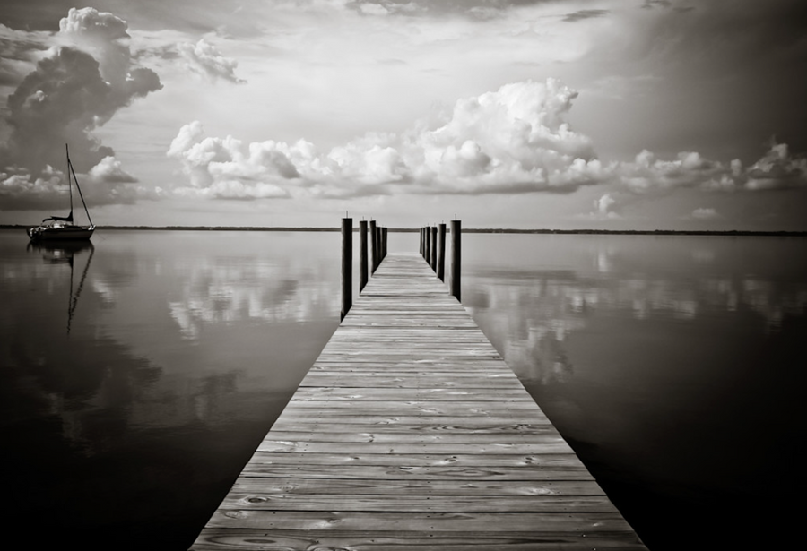 Calm coastal water reflecting soft sky near 30A dunes.
