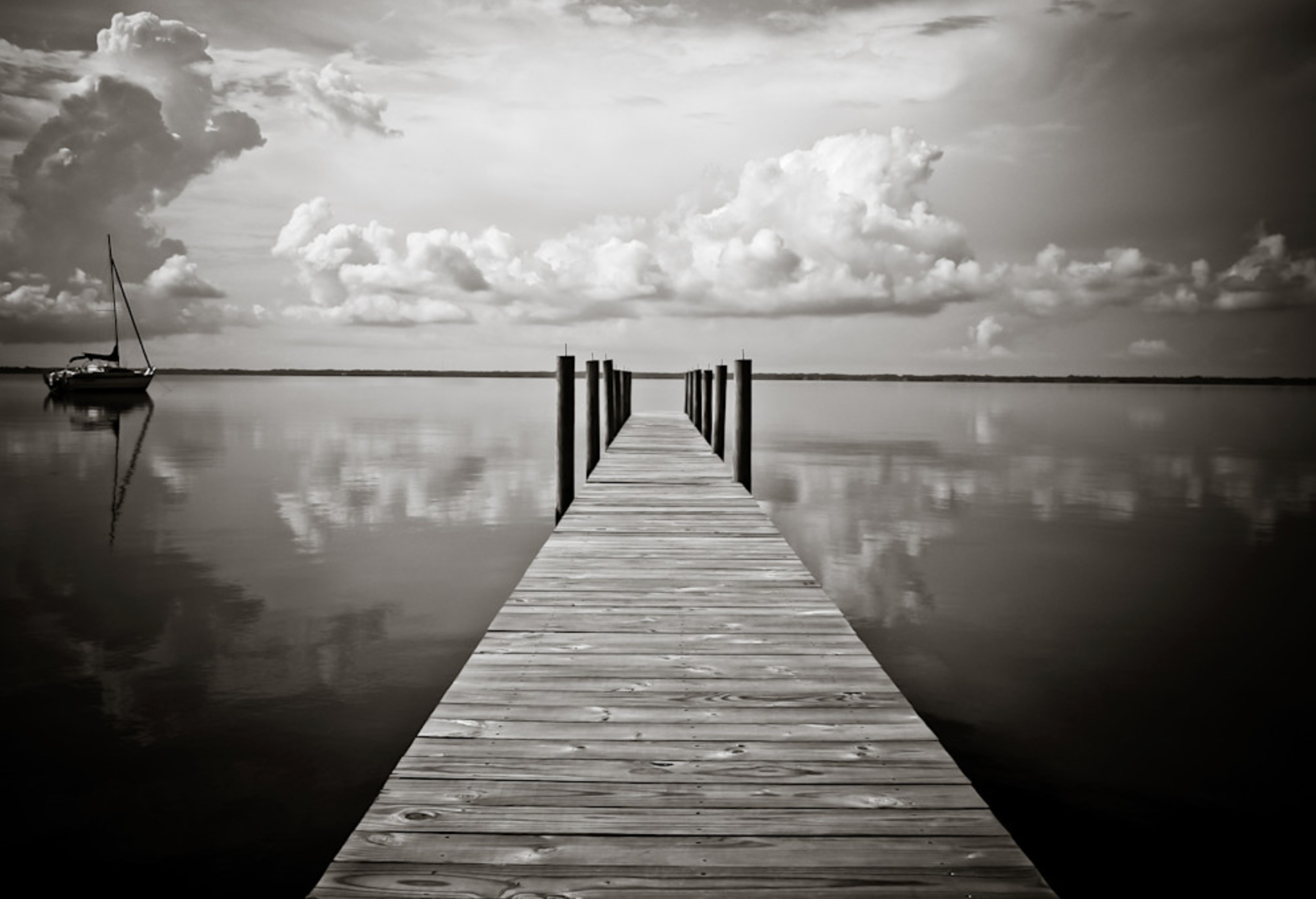 Calm coastal water reflecting soft sky near 30A dunes.