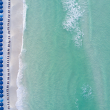Aerial photo of blue beach umbrellas along turquoise Gulf water and white sand at WaterColor Beach, 30A.