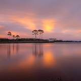 Sunset photograph of Western Lake with longleaf pine reflections and orange-pink sky, Grayton Beach Florida.